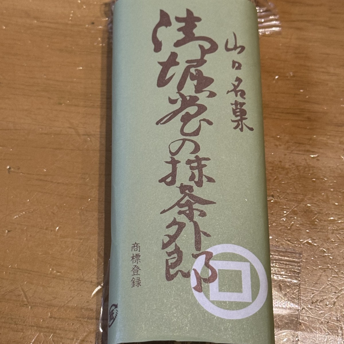 御堀堂の抹茶外郎1本。竹皮風の包み紙に緑の帯「山口名菓 御堀堂の抹茶外郎」